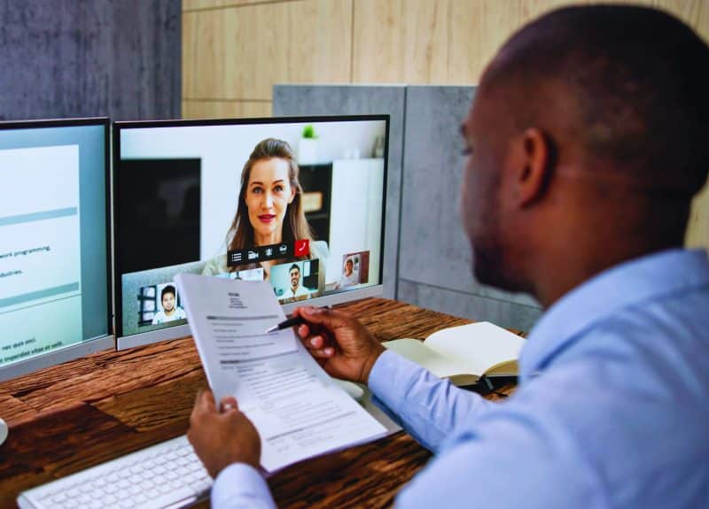 a man and woman on a video interview on their pc