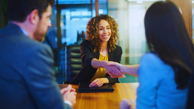woman shaking hands in an office 