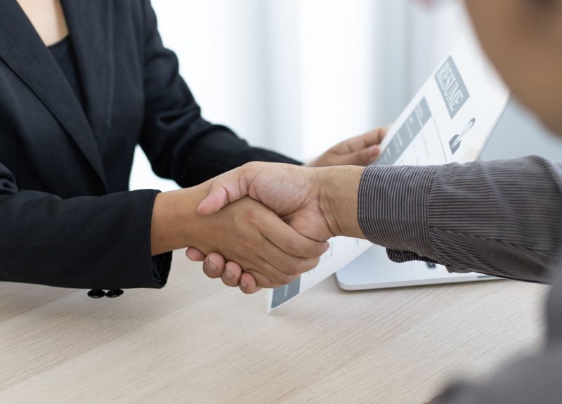 two people shaking hands with a cv 