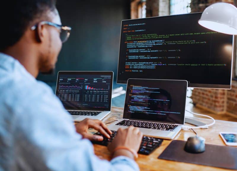 Man sat at his desk using vibe code to help write an app