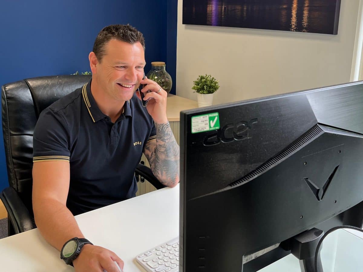 simon sat at his desk taking a call