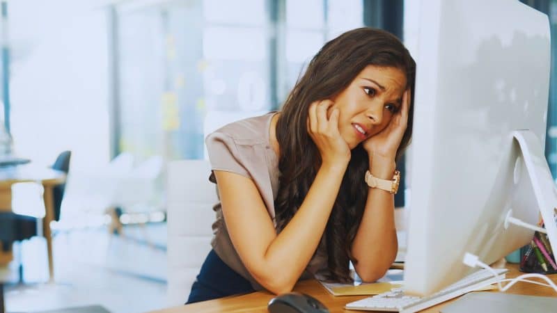 lady at her desk computer looking stressed