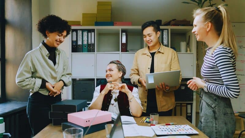 group of office workers chatting in the office