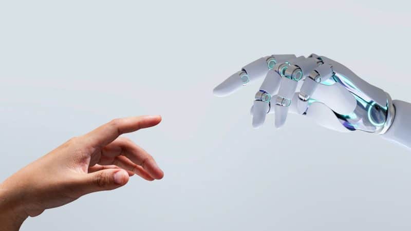 a human hand touch a robot or ai hand 