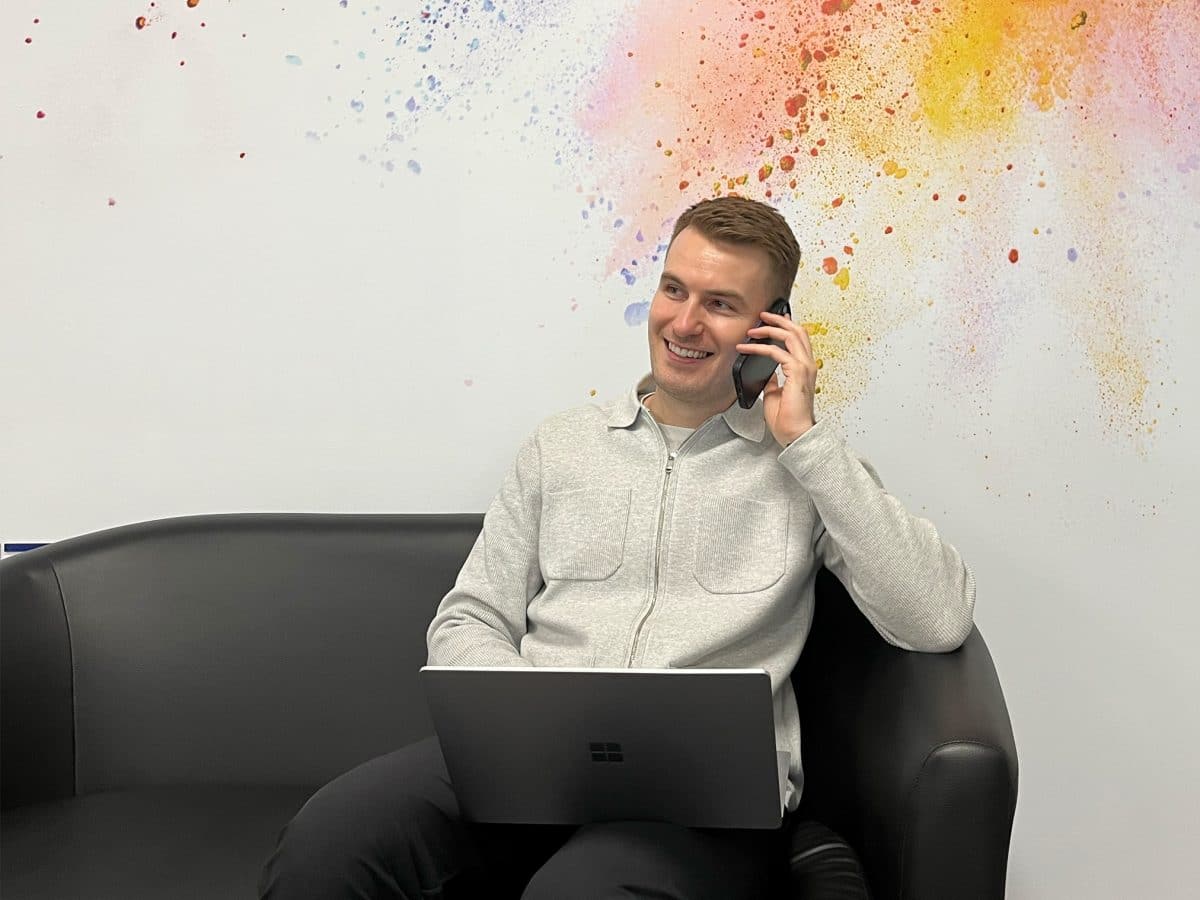 a recruiter sat on a sofa on the phone