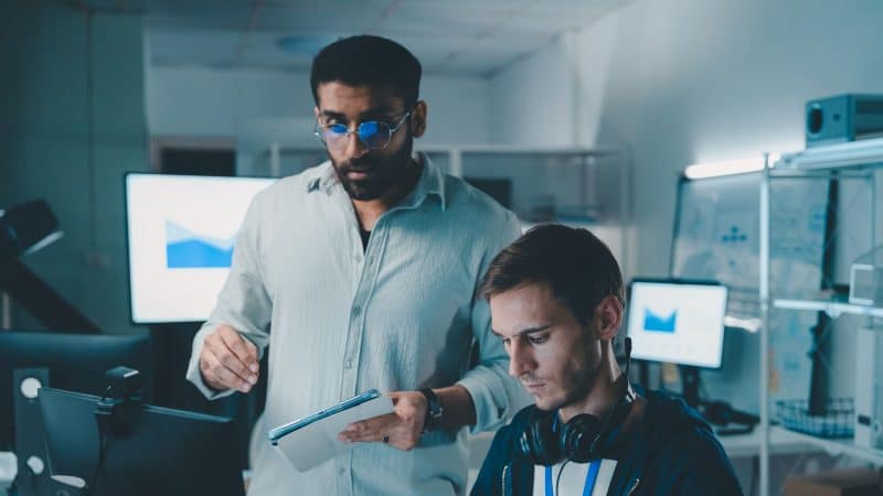 software and cloud engineers stood up looking at a computer screen